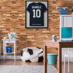 Stylish boy's room with wooden desk and pillow in football ball shape